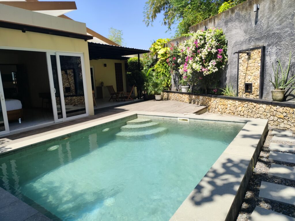 Sakuta Villa at Kalandra Estate, Kuta, Central Lombok – luxury villa with private pool, modern bedrooms, spacious living area, and tropical terrace near Kuta Beach Lombok. Sakuta Villa at Kalandra Estate, luxury villa with private pool in Kuta, Central Lombok Modern bedroom interior at Sakuta Villa Kuta Lombok with tropical ambiance Private swimming pool at Sakuta Villa near Kuta Beach Lombok Spacious living room with tropical garden view at Sakuta Villa Lombok Stylish tropical terrace at Sakuta Villa Kalandra Estate, Central Lombok Luxury villa accommodation in Kuta Lombok – Sakuta Villa private pool view Modern tropical design villa at Kalandra Estate, Kuta, Central Lombok Comfortable bedroom with pool view at Sakuta Villa Kuta Lombok Exotic tropical garden surrounding Sakuta Villa in Central Lombok Romantic sunset view from Sakuta Villa terrace in Kuta Lombok Honeymoon villa with private pool at Kalandra Estate Kuta Lombok Family-friendly luxury villa near Kuta Beach Lombok – Sakuta Villa Open living space with natural light at Sakuta Villa Central Lombok Modern bathroom with tropical design at Sakuta Villa Lombok Aerial view of Sakuta Villa Kalandra Estate near Kuta Beach Lombok, shanti yoga lombok, kuta lombok, villa kuta lombok